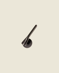 The Gaudi Curve - matte black brass door lever with fluid curved form and circular rose on neutral background