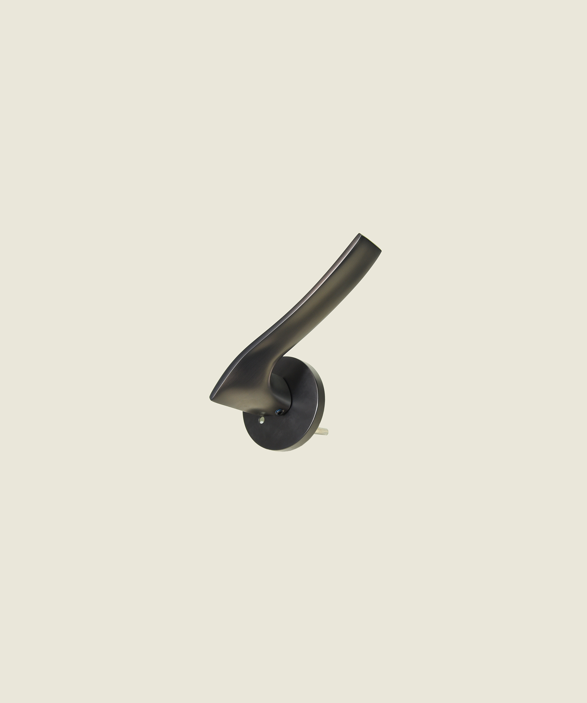 The Dali No. 4 door lever in dark bronze - dramatic curved wave form on circular rose, satin brass finish