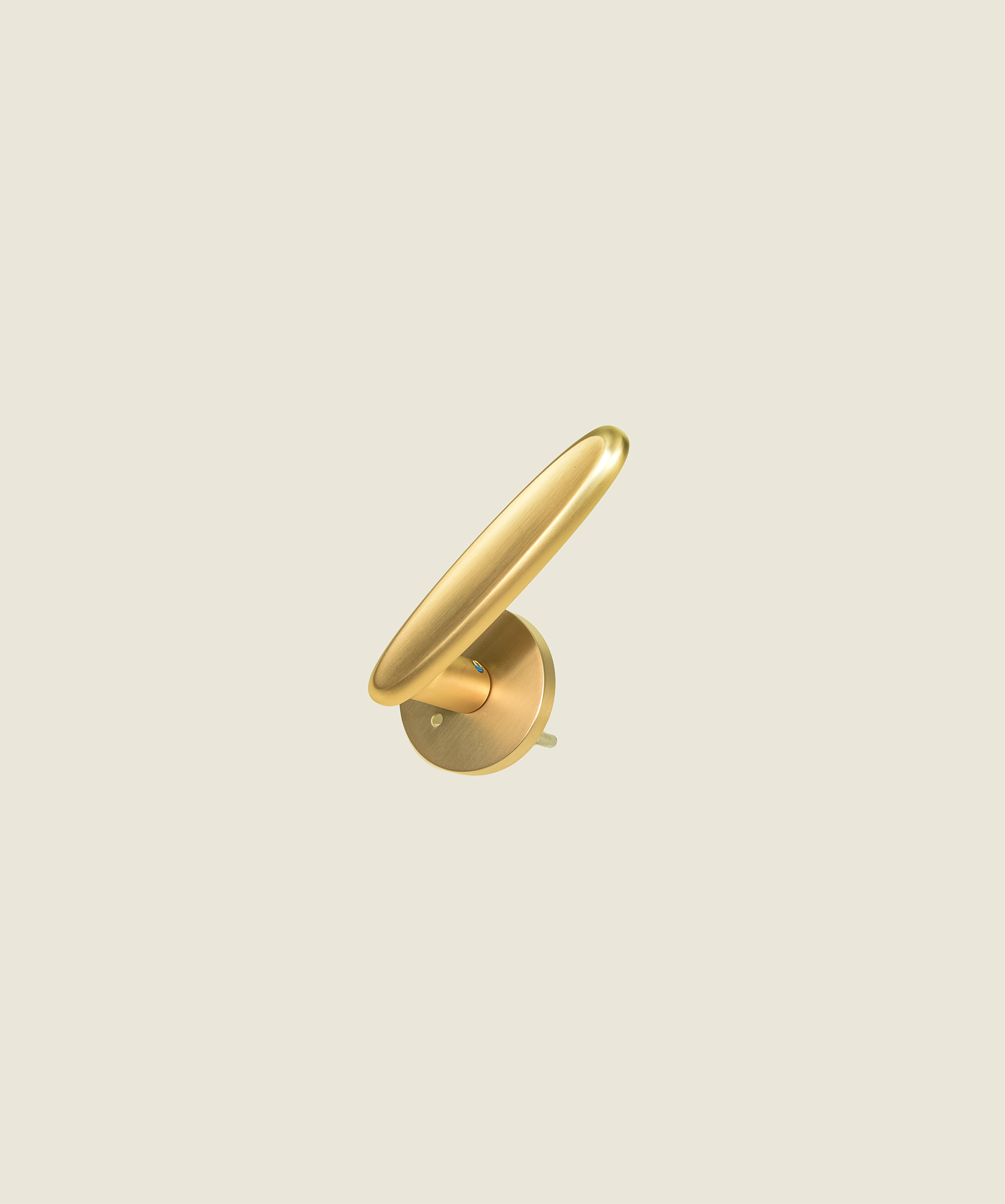 The Matisse Silhouette in polished gold - rounded sculptural door lever with warm brass finish on circular rose